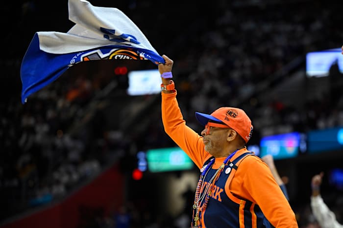 Spike Lee waves a towel during a Knicks game.